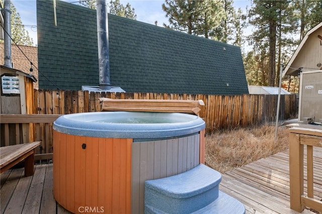 wooden deck with a hot tub