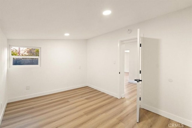 unfurnished room with light hardwood / wood-style flooring