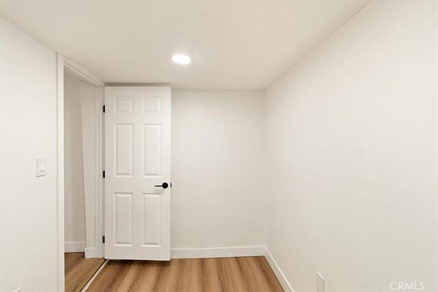 corridor with wood-type flooring