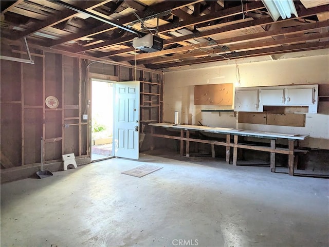 garage with a workshop area and a garage door opener