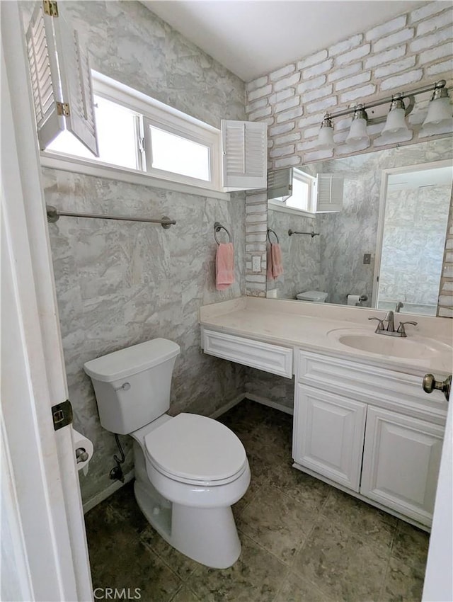 bathroom featuring toilet and vanity