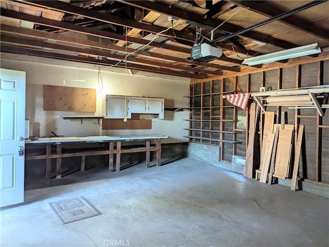 garage with a garage door opener and a workshop area