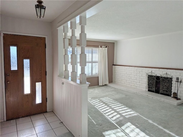 foyer entrance featuring a textured ceiling and light colored carpet