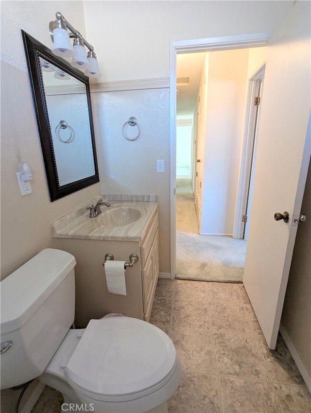 bathroom with toilet and vanity