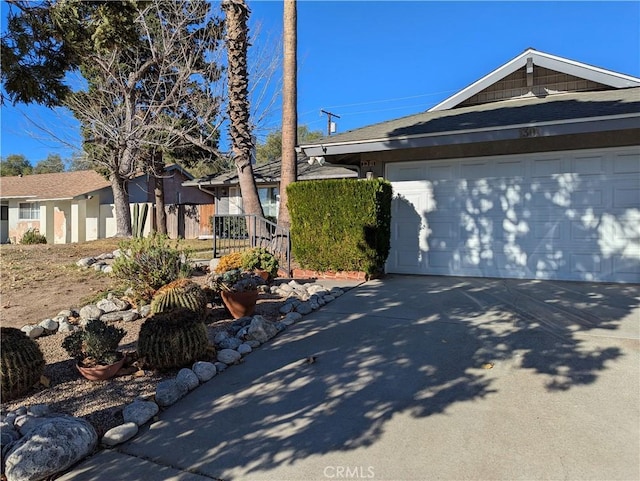 view of front of house with concrete driveway and a garage