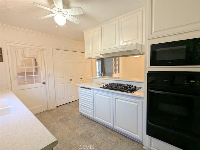 kitchen featuring ceiling fan, black appliances, sink, crown molding, and white cabinets