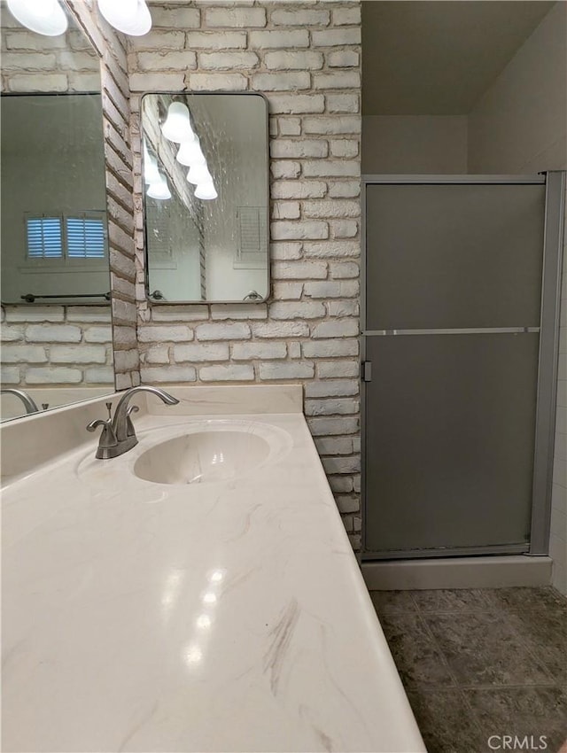 full bathroom featuring tile patterned floors, a stall shower, and vanity