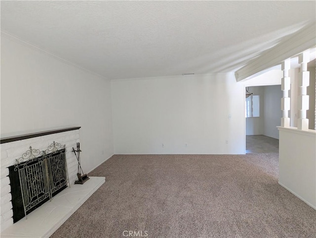 unfurnished living room featuring a textured ceiling, a brick fireplace, and carpet flooring