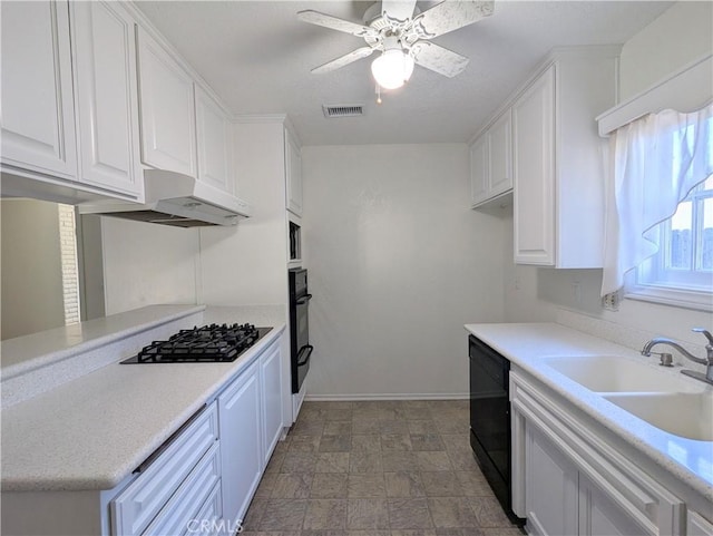 kitchen with visible vents, under cabinet range hood, white cabinets, black appliances, and a sink