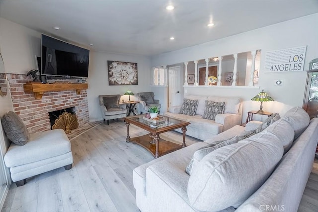 living room featuring a fireplace and light hardwood / wood-style floors