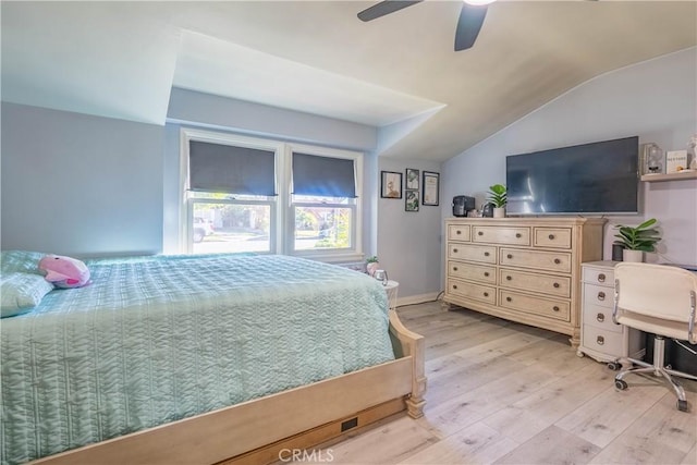 bedroom featuring ceiling fan, light wood-type flooring, and lofted ceiling