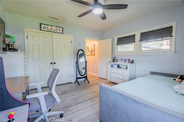 bedroom featuring ceiling fan, light hardwood / wood-style flooring, and a closet