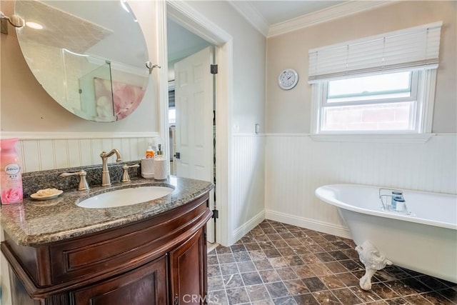 bathroom featuring vanity, ornamental molding, and a bathing tub