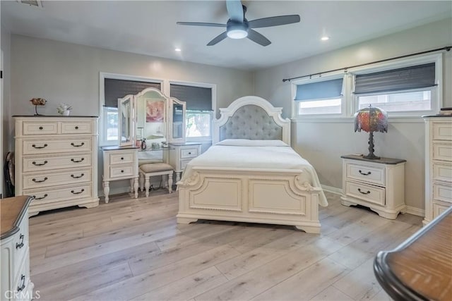 bedroom with ceiling fan and light hardwood / wood-style floors