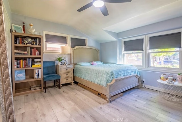 bedroom featuring ceiling fan, light wood-type flooring, and lofted ceiling