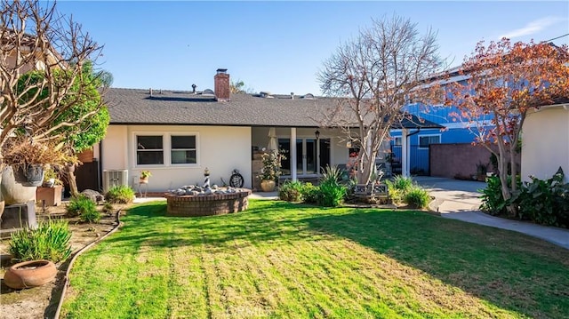 rear view of house featuring a yard