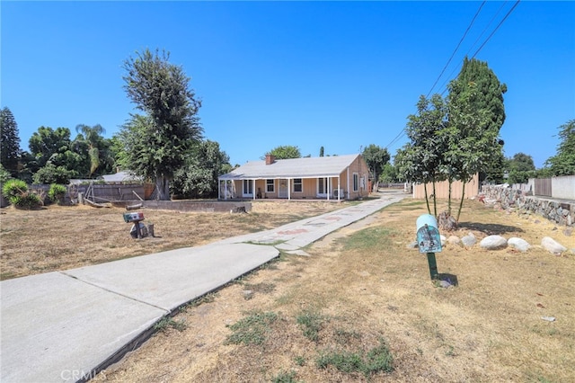 view of front of property with covered porch and a front lawn