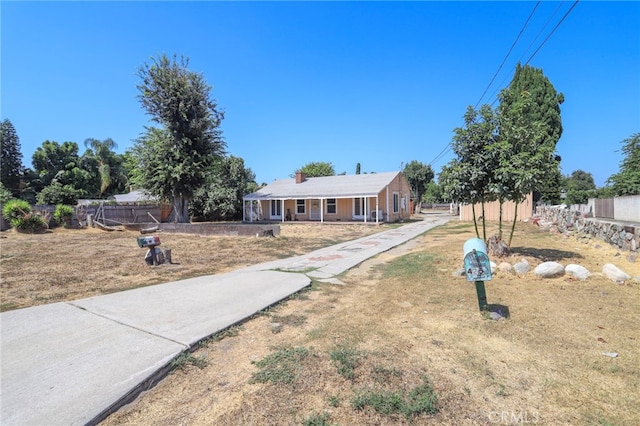 view of front of property with covered porch and a front lawn