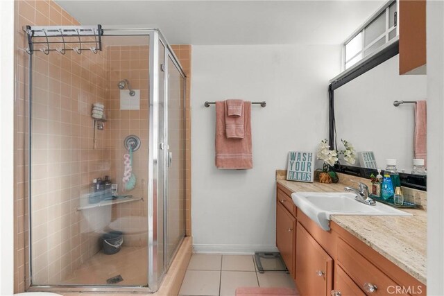 bathroom featuring tile patterned floors, walk in shower, and vanity