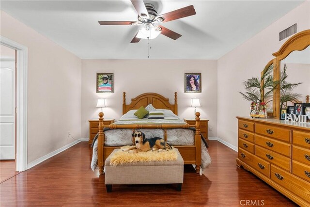 bedroom with dark wood-type flooring and ceiling fan