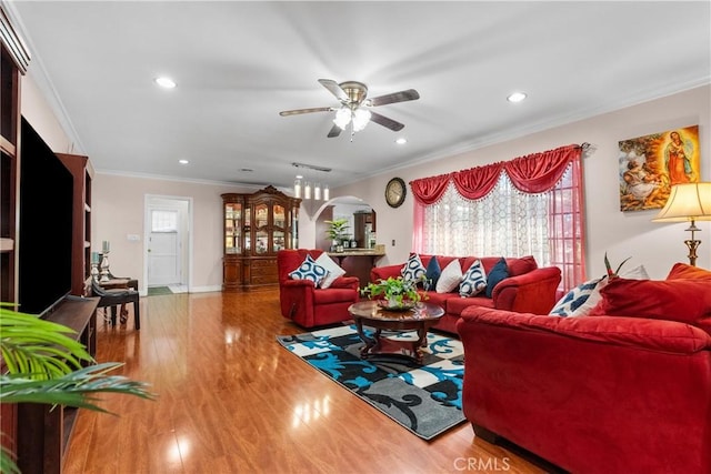 living room featuring ornamental molding, ceiling fan, and hardwood / wood-style flooring