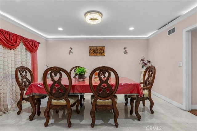 tiled dining space featuring ornamental molding