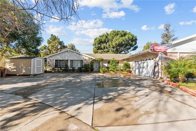 single story home featuring a garage and a storage shed