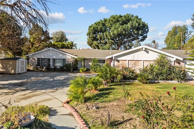 single story home with a front yard and a storage unit