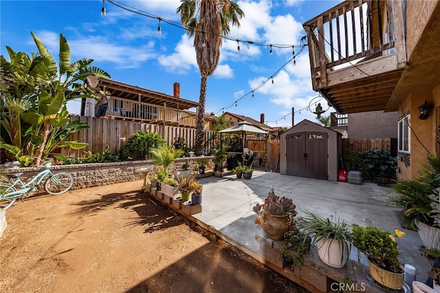 view of patio / terrace featuring a balcony and a shed