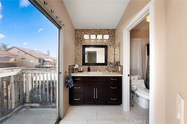 bathroom with vanity, toilet, and tile patterned flooring