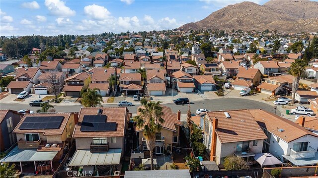 drone / aerial view featuring a residential view and a mountain view