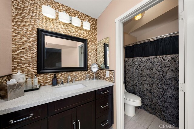 full bathroom featuring toilet, tasteful backsplash, tile patterned flooring, and vanity