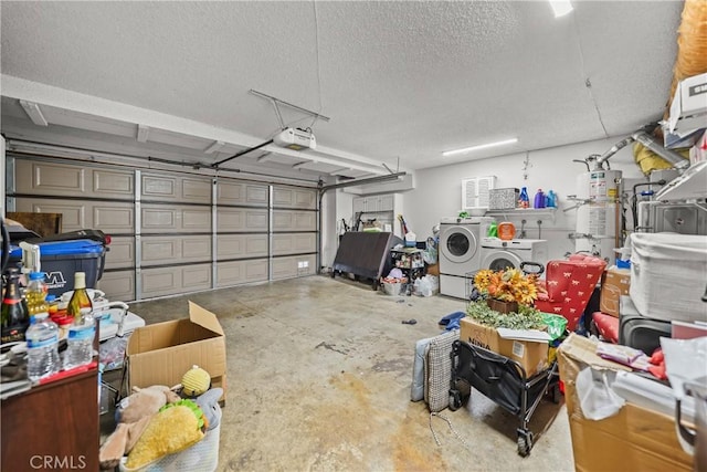 garage with washer and clothes dryer, a garage door opener, and strapped water heater