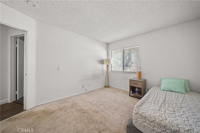 bedroom featuring a textured ceiling and carpet