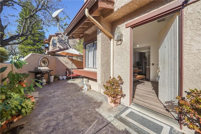 exterior space featuring a wooden deck and a patio area