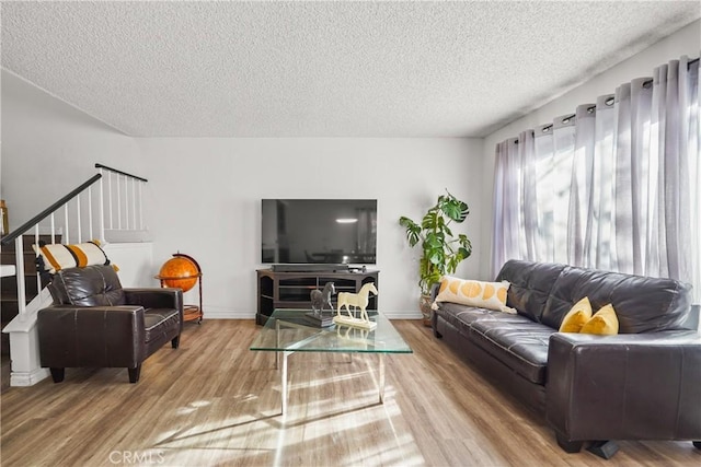 living room with a textured ceiling and wood-type flooring