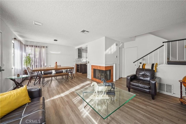 living room featuring a textured ceiling and hardwood / wood-style floors