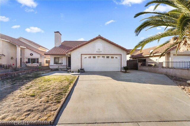 mediterranean / spanish-style house with a garage