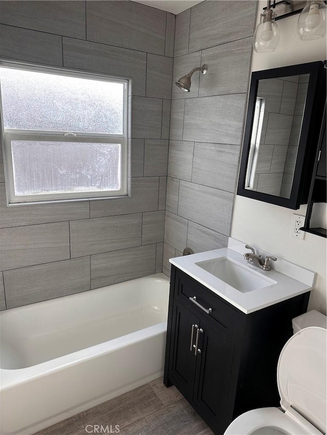 full bathroom with vanity, toilet, and tiled shower / bath combo