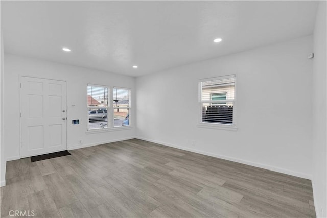 foyer with light wood finished floors, baseboards, and recessed lighting