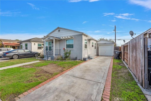 view of front facade featuring stucco siding, concrete driveway, a front yard, fence, and a garage