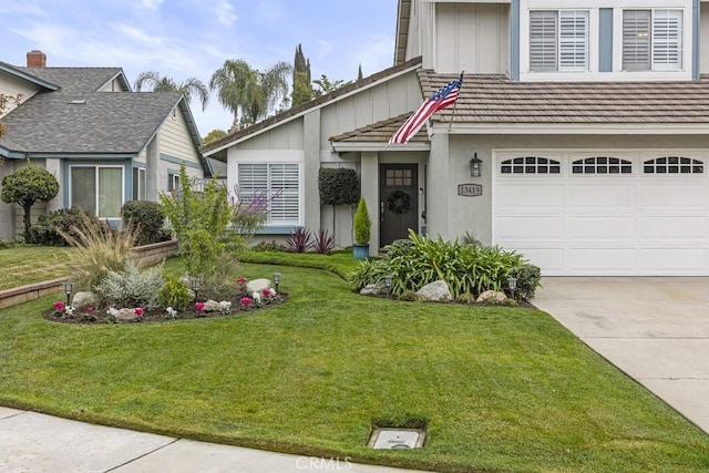 view of front of home with a garage and a front lawn