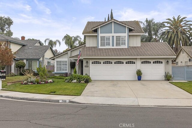 view of front of home featuring a front yard and a garage