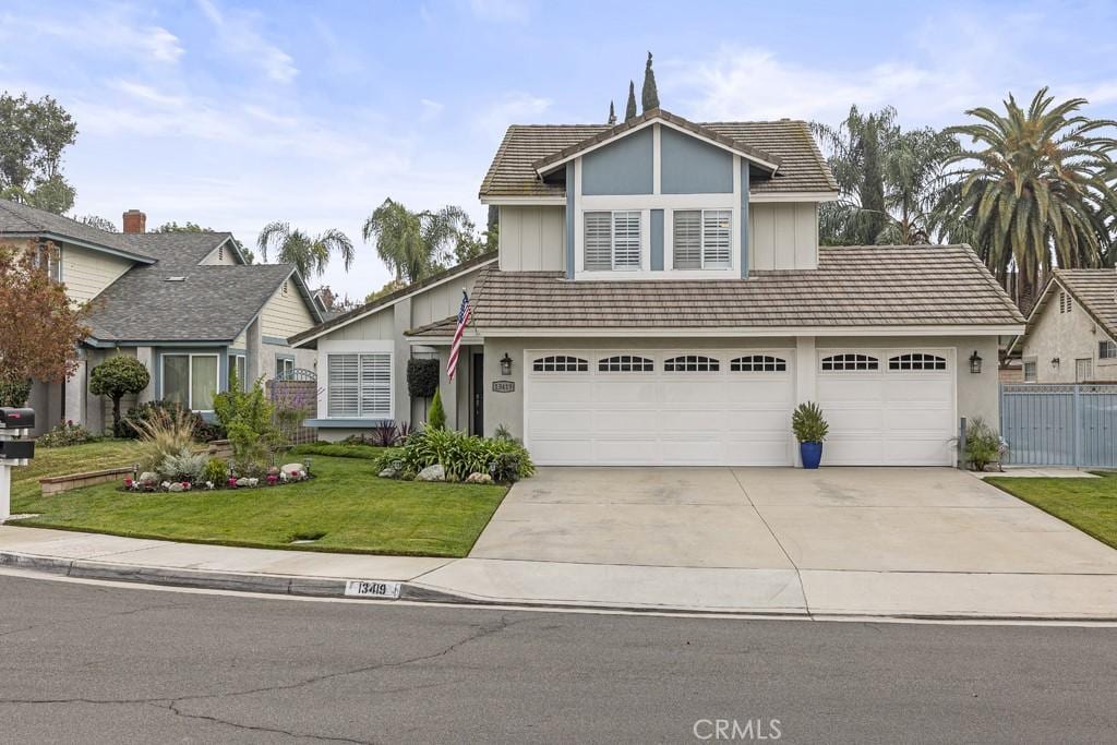 view of front of house featuring a garage and a front lawn