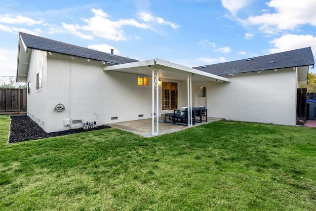 rear view of property with a yard and a patio area