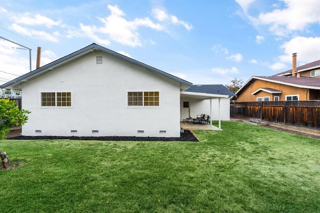 back of house with a yard and a patio area