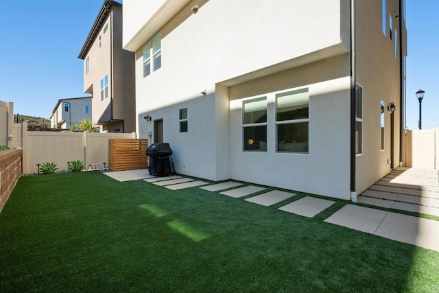 rear view of house featuring a lawn