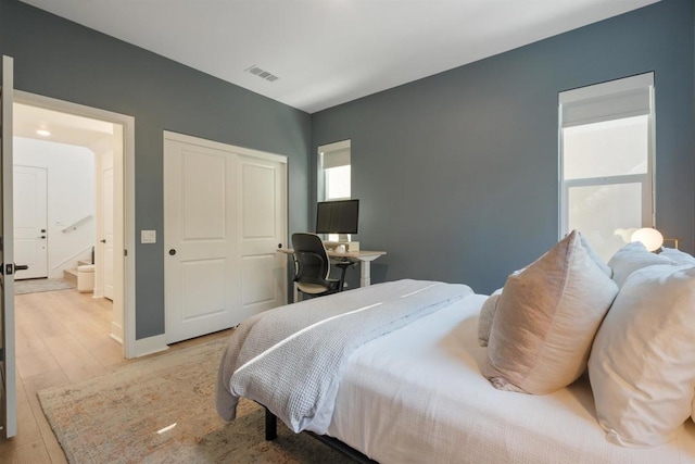 bedroom featuring light hardwood / wood-style flooring and a closet