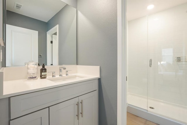 bathroom featuring an enclosed shower and vanity