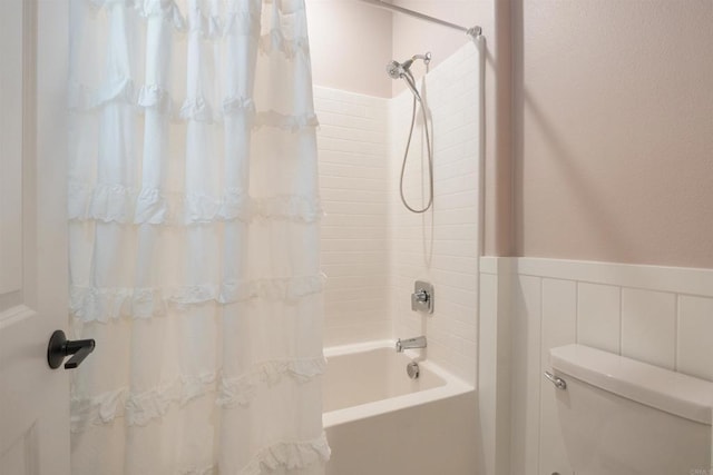 bathroom with toilet and shower / bath combination with curtain